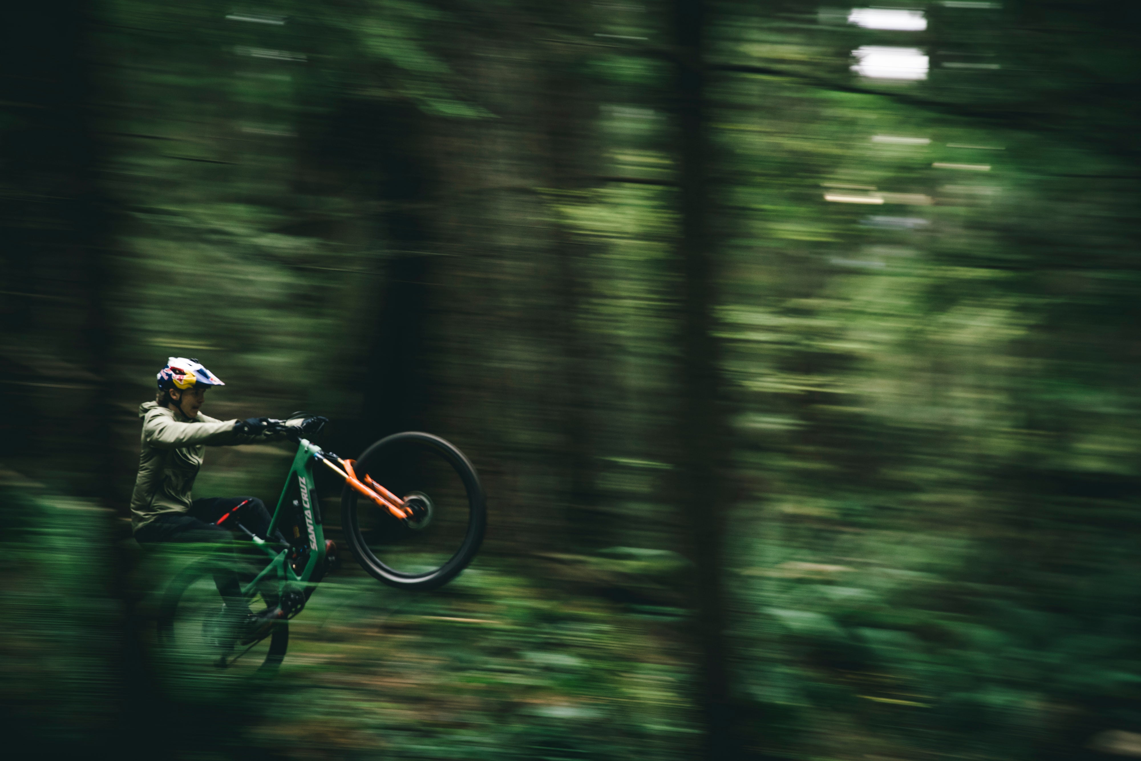 Jackson Goldstone riding a 5010 through the forest.