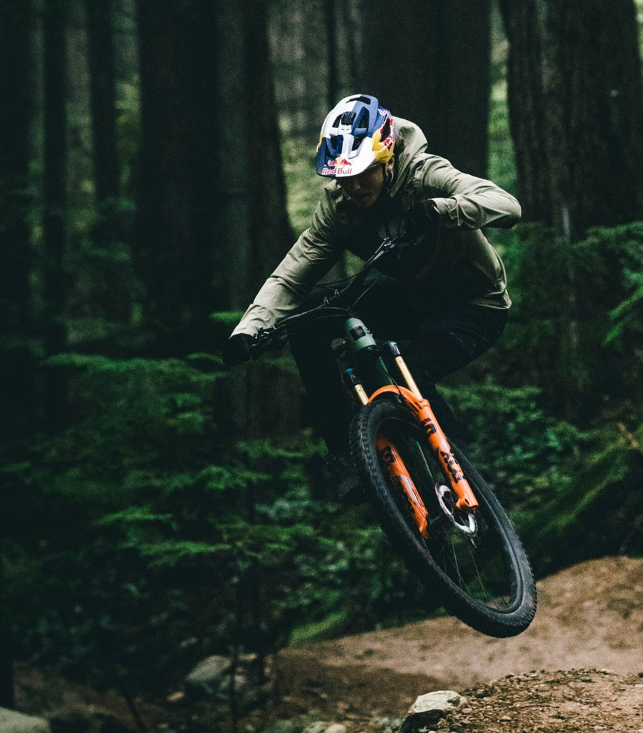 Jackson Goldstone riding a 5010 in the forrest.