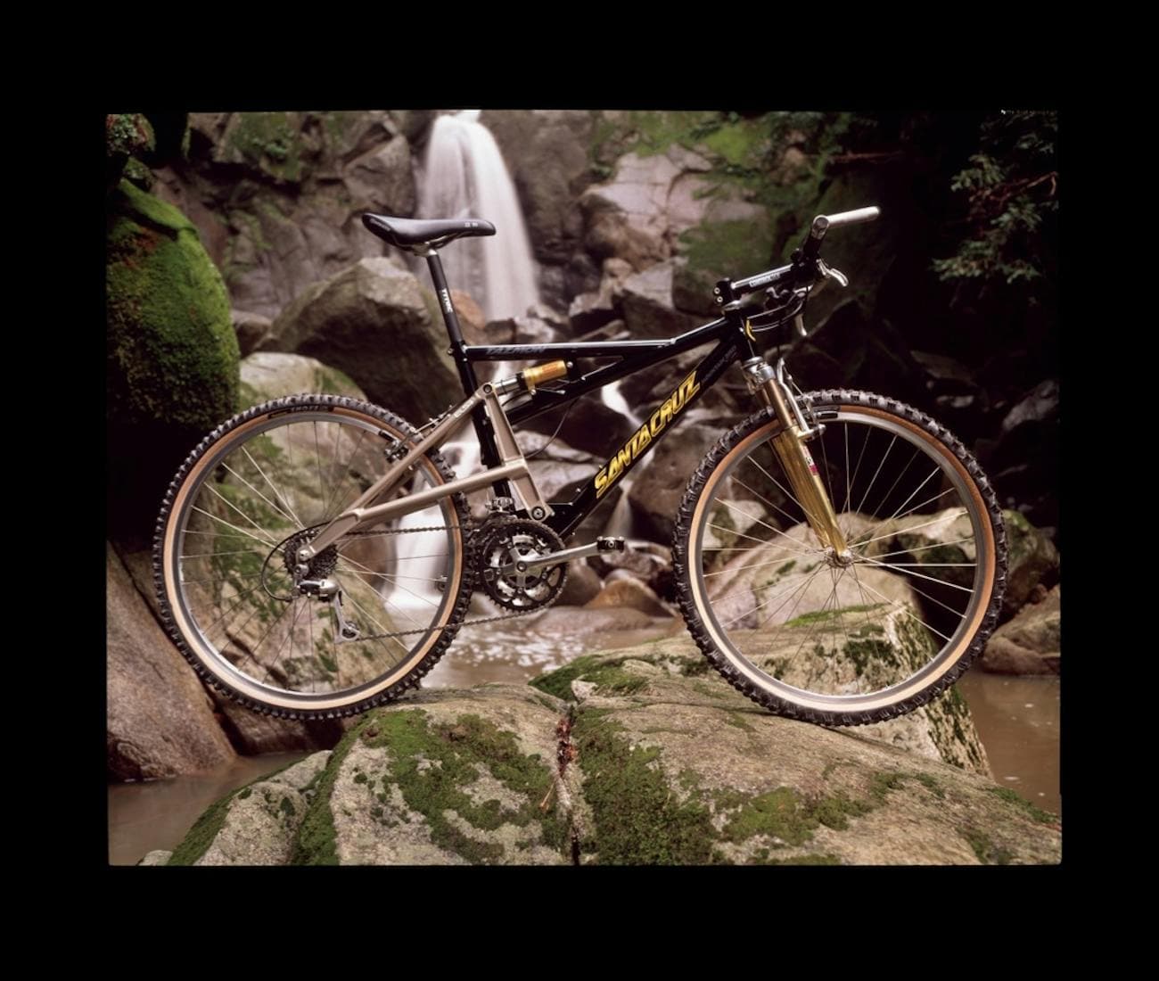 Bike on rock with waterfall in background