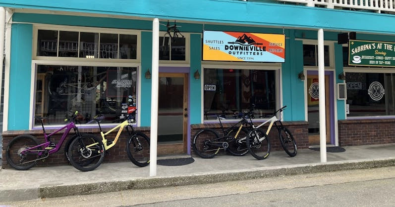 Exterior of Downieville Outfitters, showcasing mountain bikes and their vibrant storefront ready for adventurers