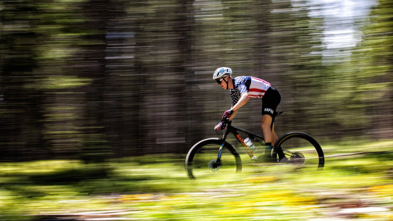 A panning photo of Keegan Swenson riding a Santa Cruz Blur