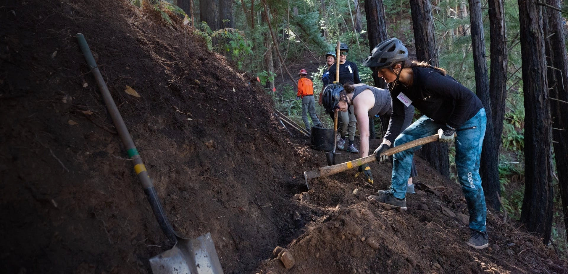 Trail builders working on trail with shovels