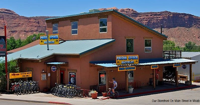 Poison Spider Bicycles storefront in Moab, Utah, featuring rustic design with bikes displayed outside