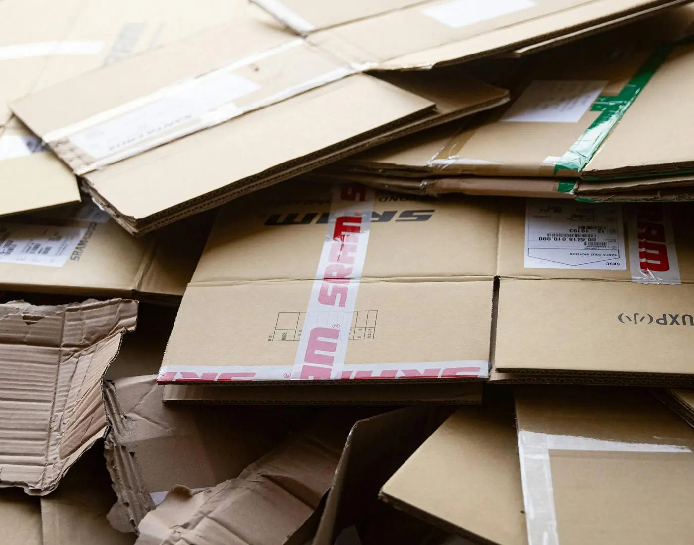 Flattened cardboard boxes labeled with 'SRAM,' ready for recycling or reuse